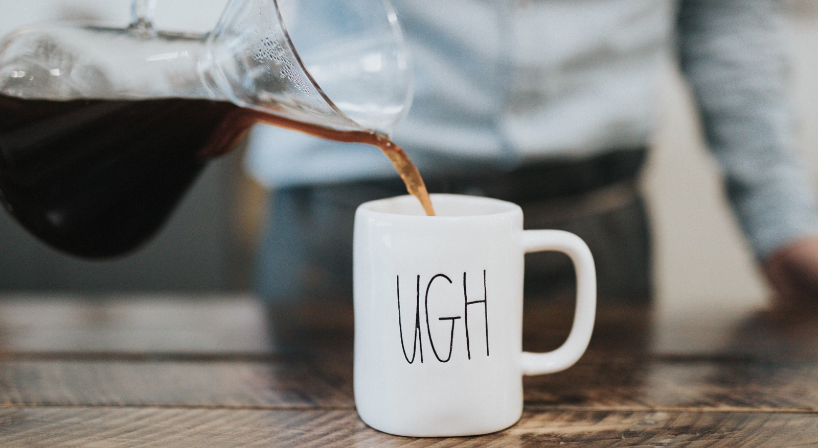 A larger amount of coffee being poured into a mug.